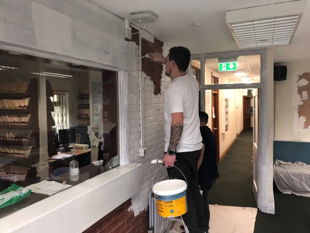 A decorator working on the reception area walls