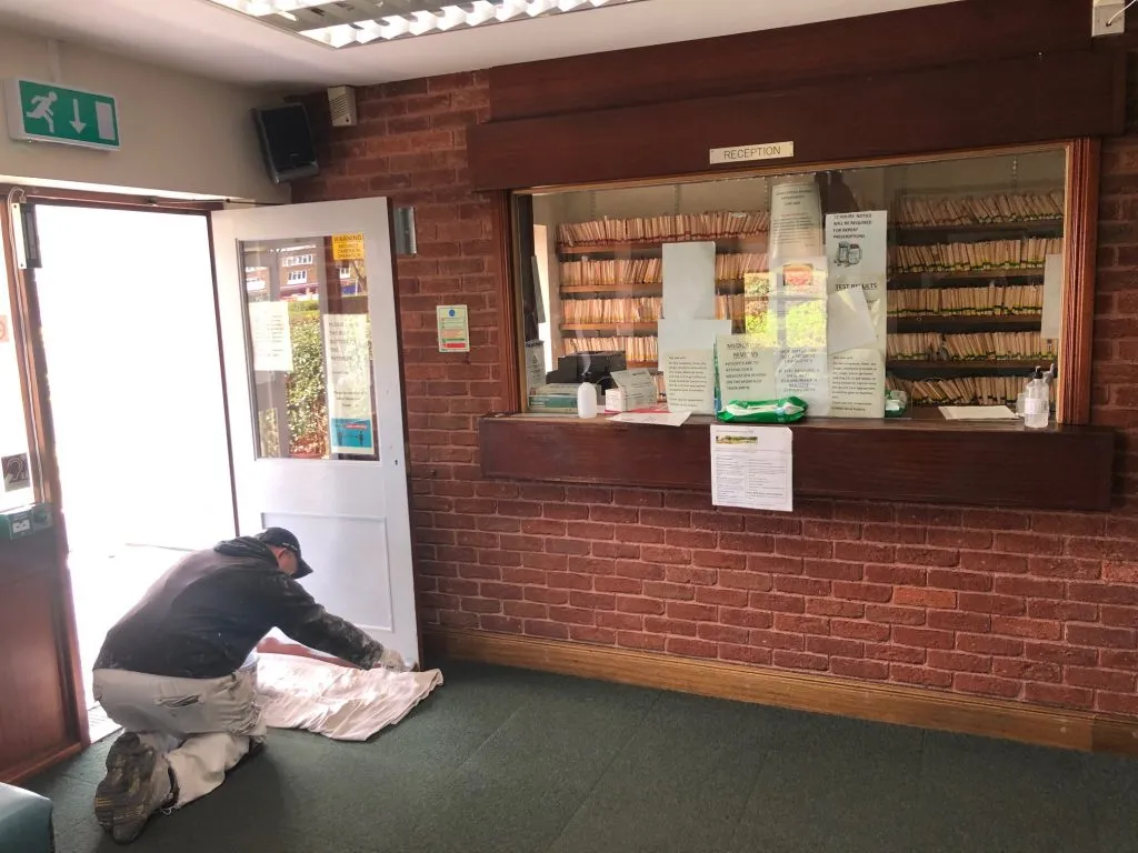 A decorator painting the reception door